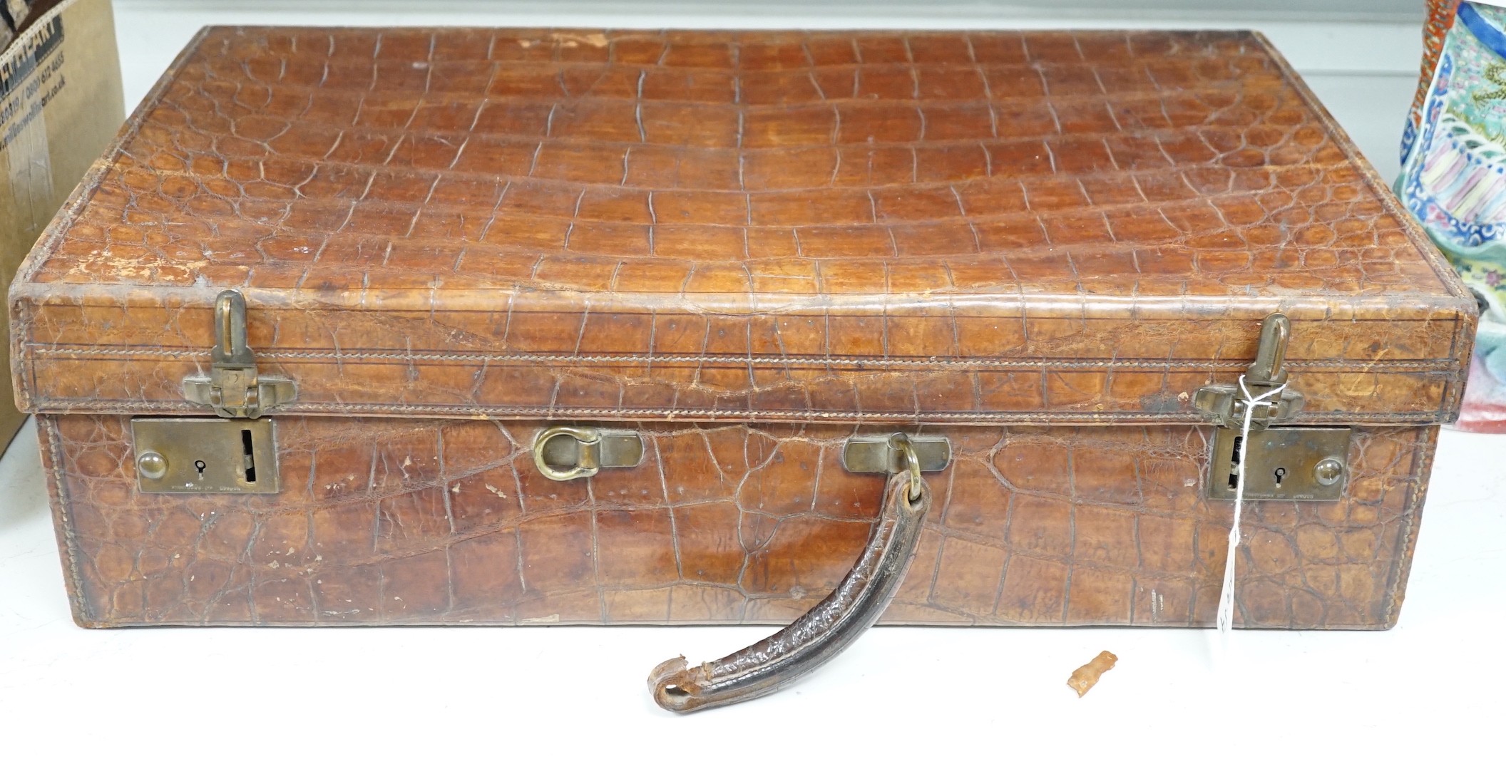 An early 20th century crocodile skin suitcase - 60cm wide